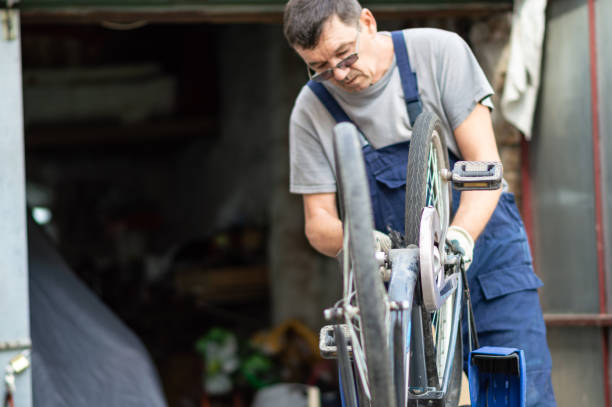 istock Hobby mechanic in overall repairs a bicycle 1150252227