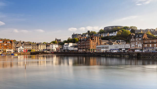 Scenic View over Oban in Scotland The Harbour of Oban and the Mccaig's Tower reflecting in the Water oban stock pictures, royalty-free photos & images
