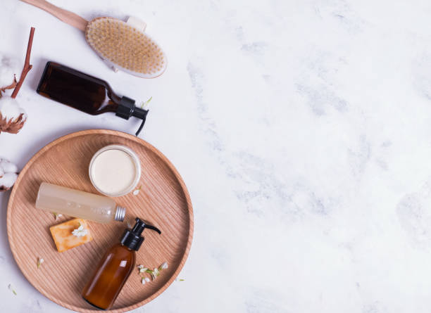istock Natural cosmetics in small bottles on the white marble table 1150254021