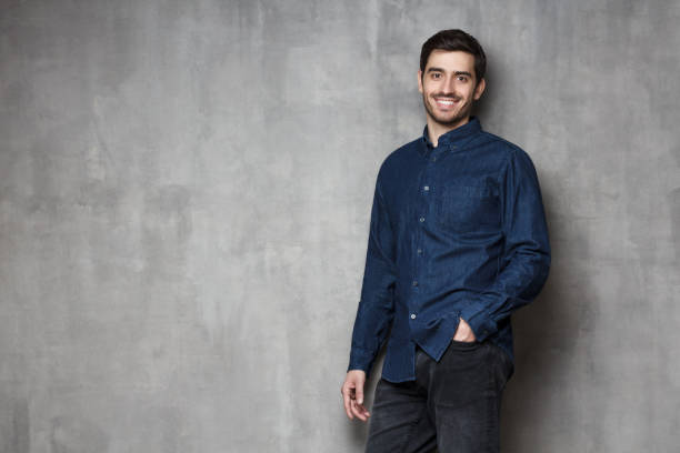 istock Positive European Caucasian guy standing against wall in relaxed convenient pose 1150254213