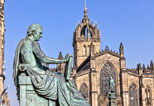 David Hume Statue and St Giles Cathedral in Edinburgh , Scotland