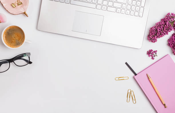 istock Modern feminine workplace with coffee and flowers 1150256262