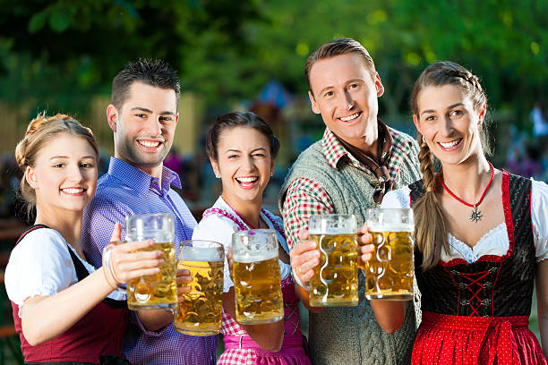 In Beer garden - friends drinking together  oktoberfest beer stock pictures, royalty-free photos & images