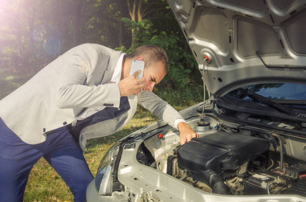 istock Man on the phone trying to get help for his broken car. Car break down. 1150262214