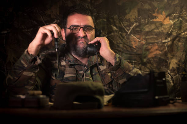 istock The evil dictator sitting on table. Angry communist general sitting at headquarter or Cuban commander in dark room. 1150262219
