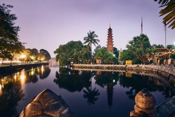 Scenic view of West lake and water reflection of Tran Quoc Pagoda - the oldest Buddhist temple in Hanoi, Vietnam.