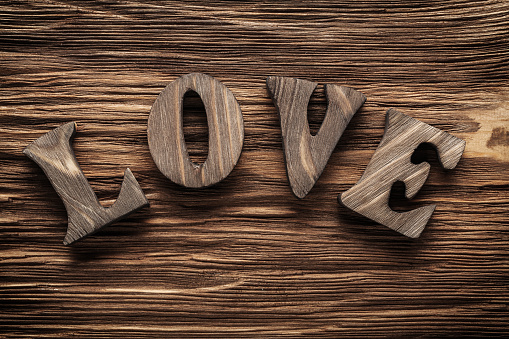 love vintage wood letters on wooden background