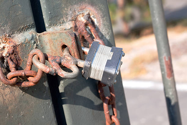 istock Rusted Chain and Fence with a Padlock 115026385