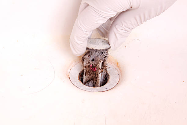 istock Nasty Dirty Hair Clog Pulled out with Sink Stopper 115026390