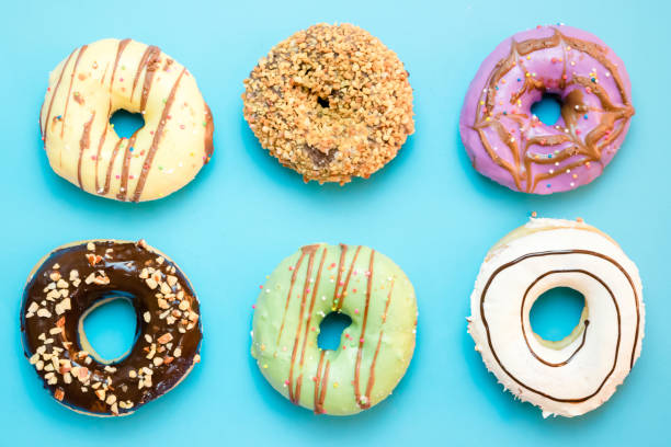 istock Donuts assorted with glazed on blue and pink background 1150265348