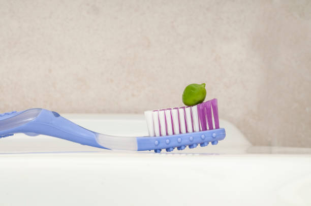 istock new toothbrush with a pea, recommended size to put the toothpaste 1150267823