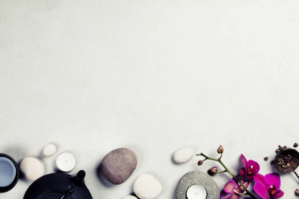 istock Asian tea set and spa stones on concrete background 1150269286