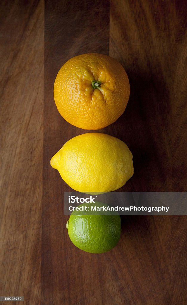 Citrus fruits Three citrus fruits in a vertical orientation. Shot in natural light, strong daylight from the left to create a sharp contrast and interesting tonal range. Color Image Stock Photo
