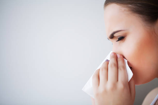 istock Flu and Sick Woman. Sick Woman Using Paper Tissue, Head Cold Problem 1150270734
