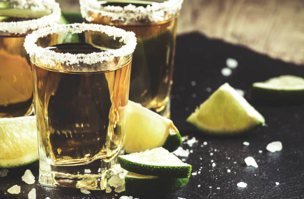 istock Golden Mexican tequila with lime and salt, selective focus 1150270771