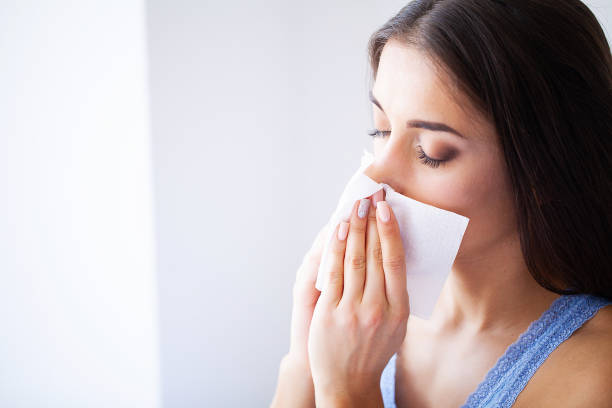 istock Flu and Sick Woman. Sick Woman Using Paper Tissue, Head Cold Problem 1150271061