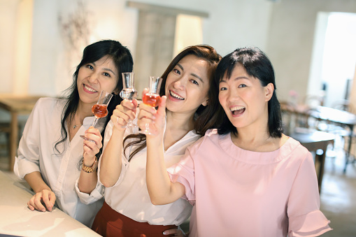 Three Asian women toasting at the restaurant