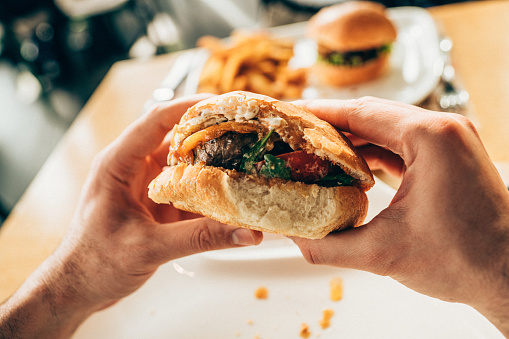 Man eating a tasty fresh burger.