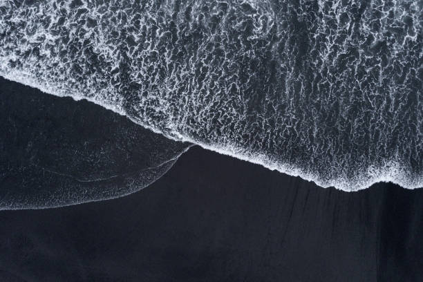 istock Aerial drone shoot from above black sand beach. Nature texture 1150277075