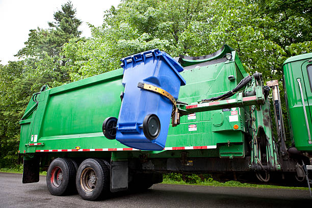 Recycling Truck Robot Arm emptying Wheeled Recycling Bin. green garbage truck stock pictures, royalty-free photos & images