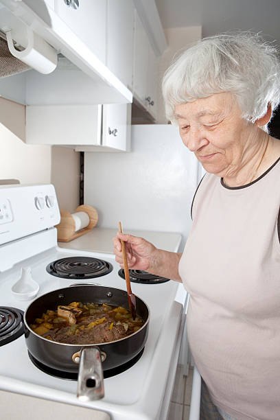 istock Grandma cooking on her stove smiling 115027798