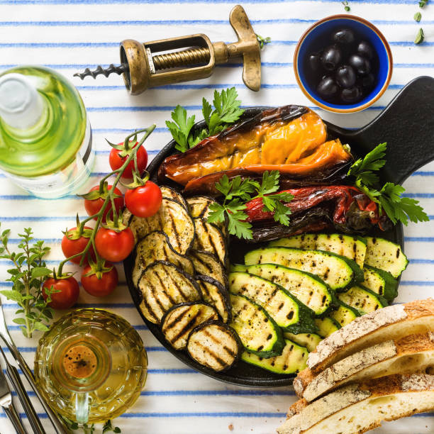 istock grilled vegetables on the table with white wine, fresh bread and aromatic herbs. summer menu 1150278167