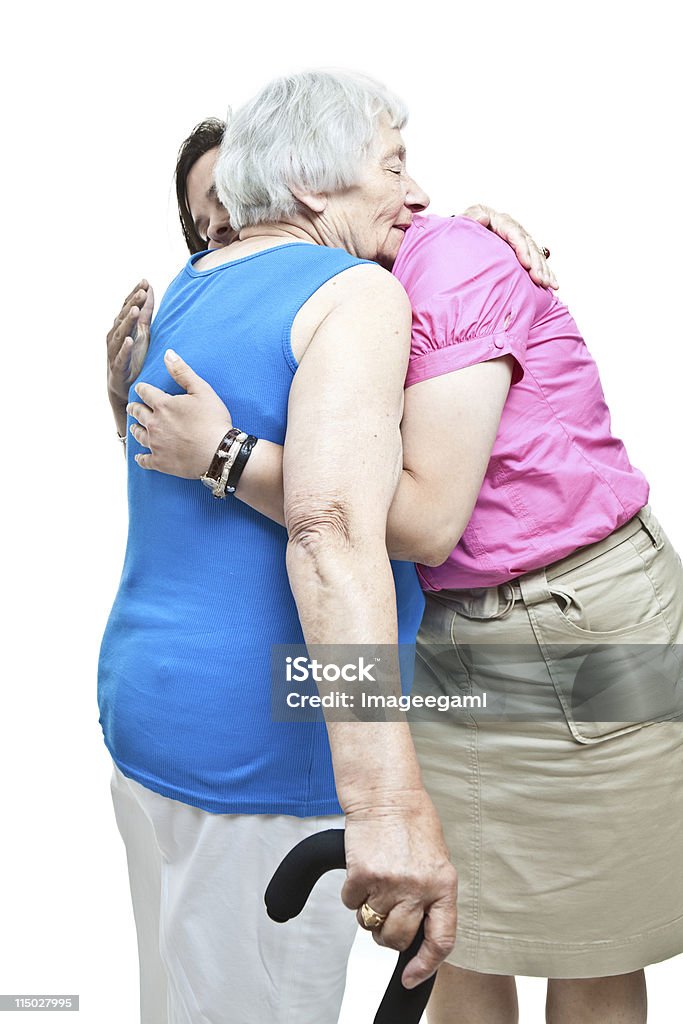 Sênior mulher abraçando neta - Foto de stock de 70 anos royalty-free