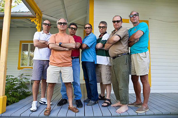 Group of men standing with arms folded on porch Similar Image stag night stock pictures, royalty-free photos & images