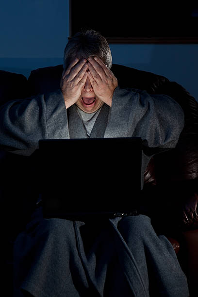 istock Man stressed out working late on laptop 115028104