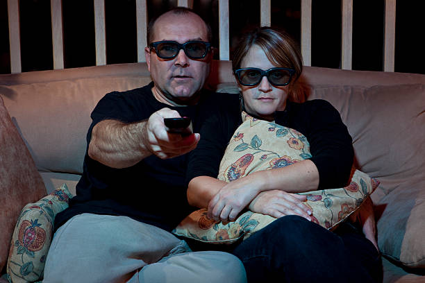 istock Couple Watching TV with 3D Glasses 115028118