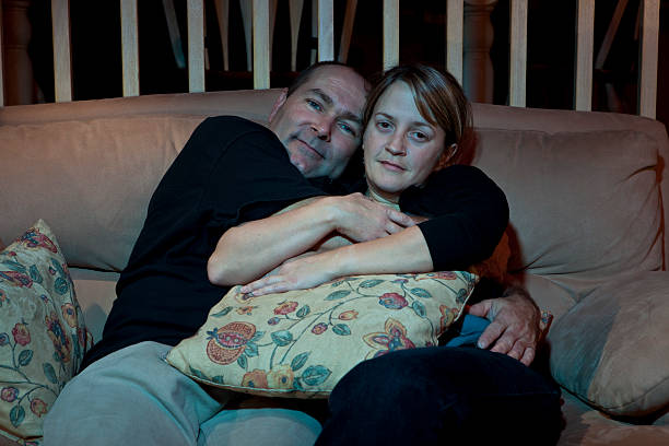 istock Couple watching TV and hugging cuddling 115028154