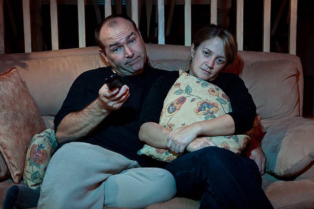 istock Chanel surfing potatoe couch couple 115028169