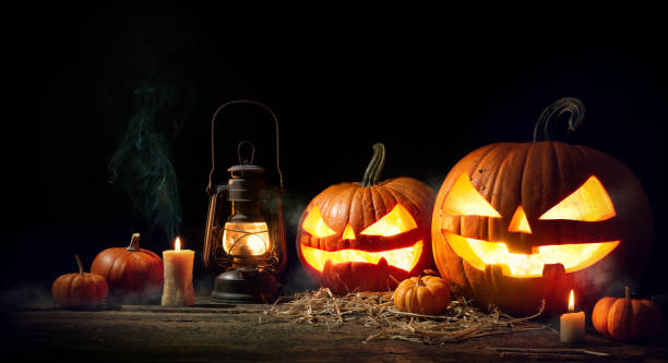 istock Halloween pumpkin head jack lantern with burning candles 1150282014