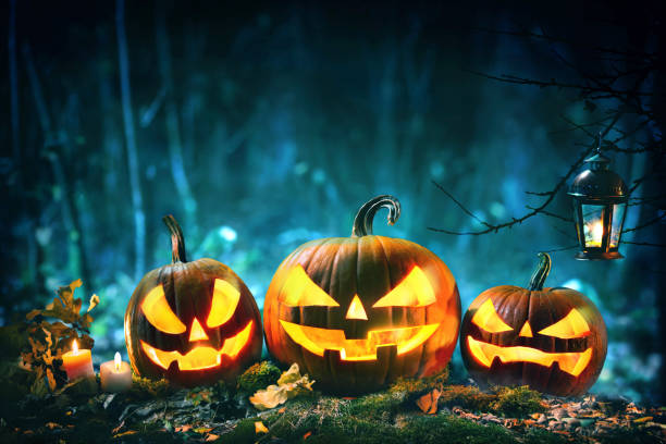 istock Halloween pumpkin head jack lantern with burning candles 1150282020