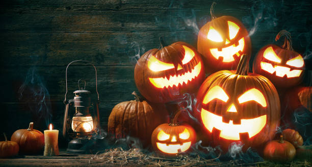 istock Halloween pumpkin head jack lantern with burning candles 1150282028
