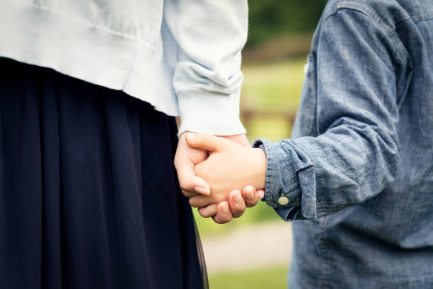 istock Mother and son holding hands in park 1150286287