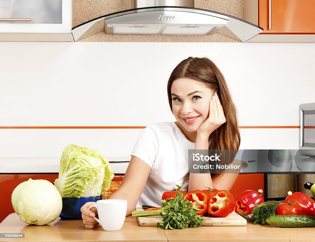 Woman at the kitchen Pretty young woman at the kitchen Adult Stock Photo