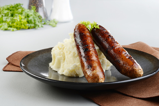 two chorizo sausages with mashed potato with parsley