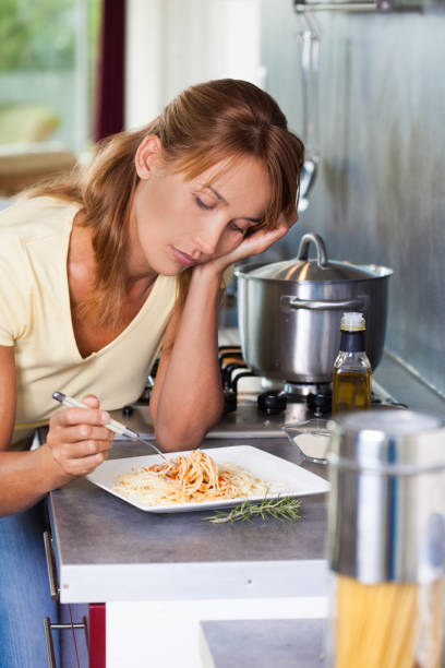 istock woman eating pasta 1150288819