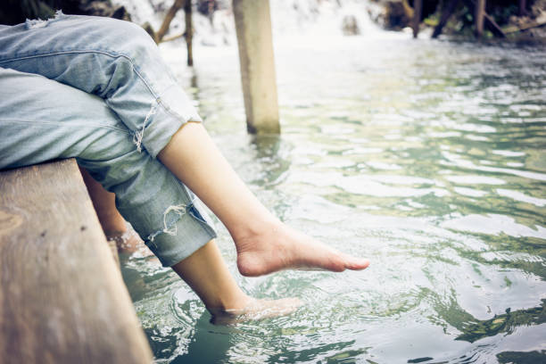 istock Woman relaxes by the river . 1150290010