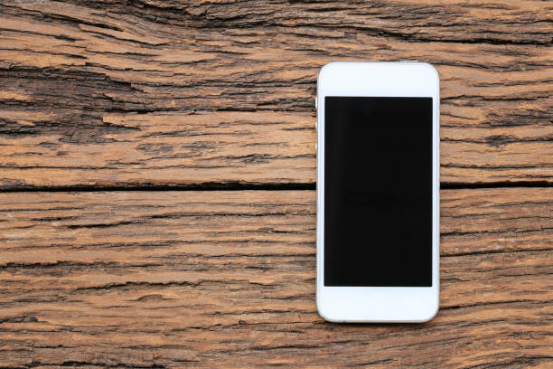 istock Empty Smartphone on brown wooden floor and have copy space. 1150293246
