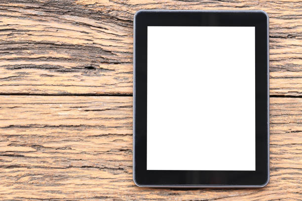 istock empty tablet on brown wooden floor and have copy space. 1150293259