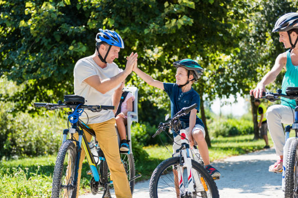 istock Family Riding Bicycle In Park 1150293512