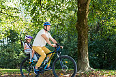 Father And Child On Bicycles In The Park