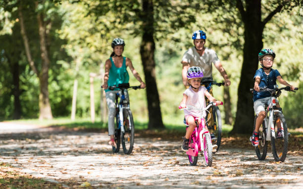 istock Family Riding Bicycle In Park 1150293552