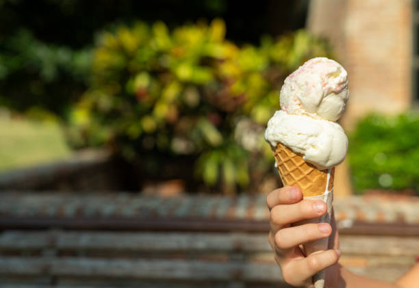 istock Young asian hand holding a double scoop ice cream 1150293582