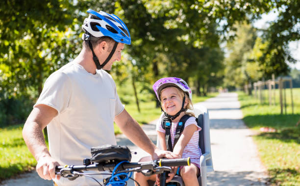 istock Father And Child On Bicycles In The Park 1150293592