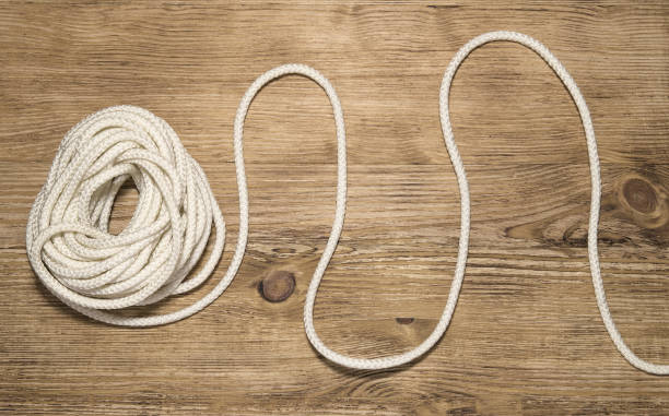 Unwinding Hank Of White Rope On The Wooden Background Solving