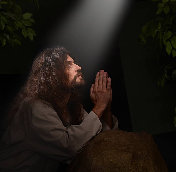 Jesus in Gesthemene Jesus praying in the Garden of Gesthemene garden of gethsemane stock pictures, royalty-free photos & images