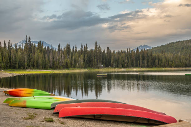 istock Kayaks and Canoes on Lake Beach 1150296913